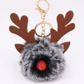 Detail of Christmas reindeer plush keychain with grey fur pompom and golden metal clasp - Two-tone Black