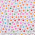 Detailed view of 4x7mm white acrylic beads with colorful heart patterns for DIY crafts - White with Colorful Hearts