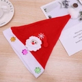 Flat lay of a red plush Christmas hat with Santa Claus design and shiny snowflakes - Cartoon Santa Claus Brushed Hat for Kids (Non-LED)