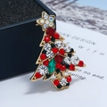 Macro view of colorful crystal rhinestones on a gold-tone Christmas tree brooch - KC Gold