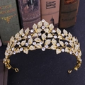 Elegant gold leaf crown with rhinestones for weddings on a vintage book background - Gold