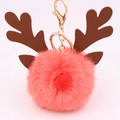 Detail of pink plush pompom keychain with brown reindeer antlers and gold metal clasp - Orange Red