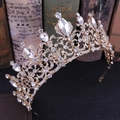 Close-up of golden Baroque bridal crown with sparkling rhinestones and hollow metalwork - KC Gold + White Rhinestone