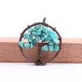 Handmade copper wire tree of life pendant with vibrant turquoise chips on wood - Turquoise