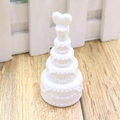 Close-up of white heart-shaped bubble wand bottle on wooden floor for wedding decor - Cake