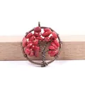 Handmade copper wire Tree of Life pendant with red gemstone chips on wooden display - Red Coral