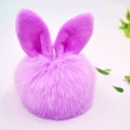 Close-up of a purple faux fur pompom keychain with cute rabbit ears on a white background - 8cm Pom Pom + Rabbit Ears / Light Purple