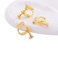 Golden U-shape earring converter for non-pierced ears shown on a white display stand - Screw Earring Clip Side Hole / Gold