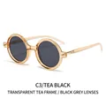 Gafas de sol redondas retro con montura té y lentes gris oscuro sobre fondo blanco - Montura Té Transparente Lentes Gris Negro