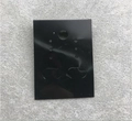 Detail einer schwarzen PVC Schmuckkarte mit Fashion Jewelry Aufdruck auf grauem Stoff - PVC Schwarz