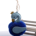 Detail of swan keychain with light blue leather wings and a fluffy navy plush pompom - 8cm Fur Ball Gold Chain Buckle / Sapphire Blue