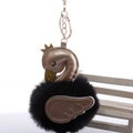 Close-up of black pom-pom swan keychain with golden crown and wing on white background - 8cm Fur Ball Gold Chain Buckle / Black