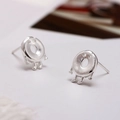 Minimalist silver doughnut-shaped person stud earrings with a matte brushed metal finish - Little Monster