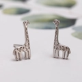 Minimalist silver giraffe stud earrings with polished metallic finish and detailed texture - Giraffe