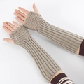 Macro detail of khaki knitted fingerless gloves featuring cable and vertical ribbed textures - One Size / Light Gray