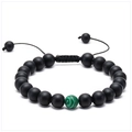Detail of adjustable lava stone bracelet with green malachite accent on white backdrop - Matte Black Beads with Single Malachite (No. 9)