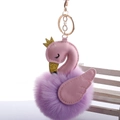 Detail of a swan keychain with a purple fur pompom, pink wings, and golden crown - 8cm Fur Ball Gold Chain Buckle / Violet