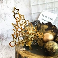Close-up of golden acrylic Christmas tree cake topper with Merry Christmas engraving - Style 320 / Mirror Gold