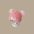 Pink knitted winter baby hat with bear ears and cute patch on a warm neutral background - Korean Style Children's Pink (2 Months - 2 Years Old)