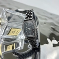 Close-up of a tonneau-shaped emerald-style watch with diamond bezel and black metal band - Gun Black Black Dial