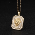 Macro shot of gold octagonal lion head pendant with sparkling clear rhinestones - Gold Lion Head