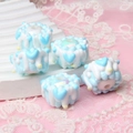 Detail of 5 blue and white layered cake charms made of acrylic for DIY bead crafting - Blue Cream Cake Bead