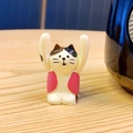 Cute white cat figurine with black spots and pink vest holding a blank sign - Calico Cat Style