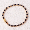 Detail of gold tennis bracelet featuring alternating blue turquoise and clear zircon stones - Blue Bracelet-Gold