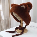 Close-up of brown plush hat with bear ears, thick faux fur texture and windproof straps - Brown