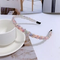 Detailed view of colorful beaded woven headband with pastel pearls and fabric ends - Colorful