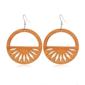 Macro detail of geometric hollow wood earrings with a radial cutout design and metal hooks - Style 49/Round Radial Hollow Log