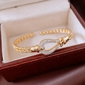 Close-up of 18K gold plated teardrop bracelet with horseshoe buckle in a gift box - Gold