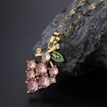 Chic golden necklace with pink zircon grape pendant and green enamel leaf detail - 9069 Pink Grape