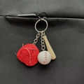 Baseball keychain set with red glove, white ball, and brown bat hanging on a black bag - Small Baseball Glove and Bat Set / Red