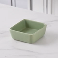 Minimalist square ceramic snack bowl in a matte green finish on a marble surface - Matcha Green