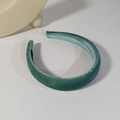 Close-up of padded velvet headband in teal blue on a white background with soft shadows - Light Green