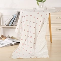 Close-up of double-sided baby blanket with cherry print and soft minky dot texture - 100X70 / Cherry