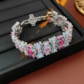 Detailed macro view of vintage silver bracelet featuring pink and red inlaid gemstones - Bracelet - Silver-Pink-Blue-Magenta