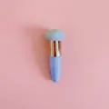 Detail view of a bullet-shaped blue makeup sponge brush with a rose gold metal ring - Single Pack / Rose Gold Tube + Blue Mushroom Head