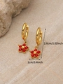 Gold hoop earrings featuring red crystal flower pendants for December birthstone style - January Red