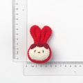 Handmade knitted white bunny pendant with red ears and base shown with ruler for scale - Red Rabbit Ear Doll Head