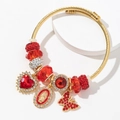 Bracciale a spirale dorato con perline di cristallo rosso e ciondolo Maria - Rosso