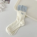 Calze bianco panna con bordo a contrasto azzurro e ricamo a fiocco elegante - Taglia unica / crema