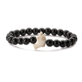 Detail shot of a black polished beaded bracelet with a white dolphin-shaped centerpiece - Glossy Black Stone Bracelet