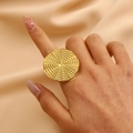 Macro detail of gold-plated starfish ring with intricate woven texture on index finger - Woven Texture Circle (s14)
