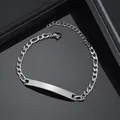 Close-up of polished silver Figaro chain bracelet with blank rectangular ID metal plate - 1:3 NK Chain / Steel