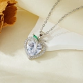 Macro detail of heart-shaped silver pendant with clear zircon and green stone accent - Silver White Zircon Heart Necklace (T021)