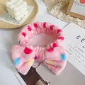 Plush pink headband with colorful polka dot bow for skincare and makeup routines - Pink Colorful Polka Dot