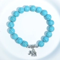 Unisex turquoise beaded bracelet featuring a silver elephant pendant and gold veined beads - Blue Turquoise Elephant Charm