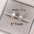 Macro detail of 5x7mm teardrop zircon stud earrings in a premium gray velvet jewelry box - 7MM Water Drop Gold